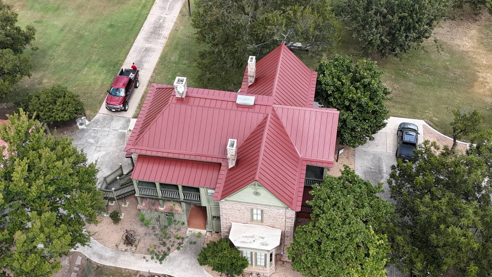 Red Metal Roof Installation on Historic Badger House in Marble Falls image